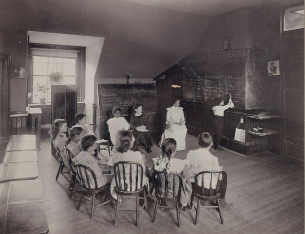 A classroom scene with teacher Mabel Adams and students. circa 1898-1899